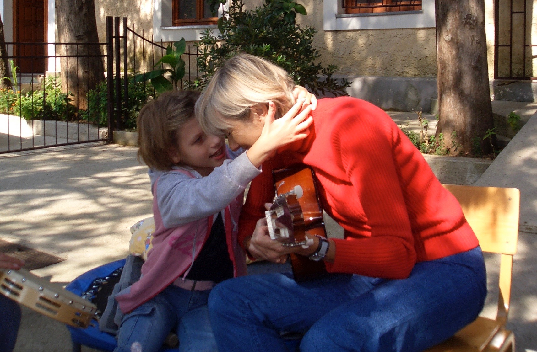The author playing guitar with a child.